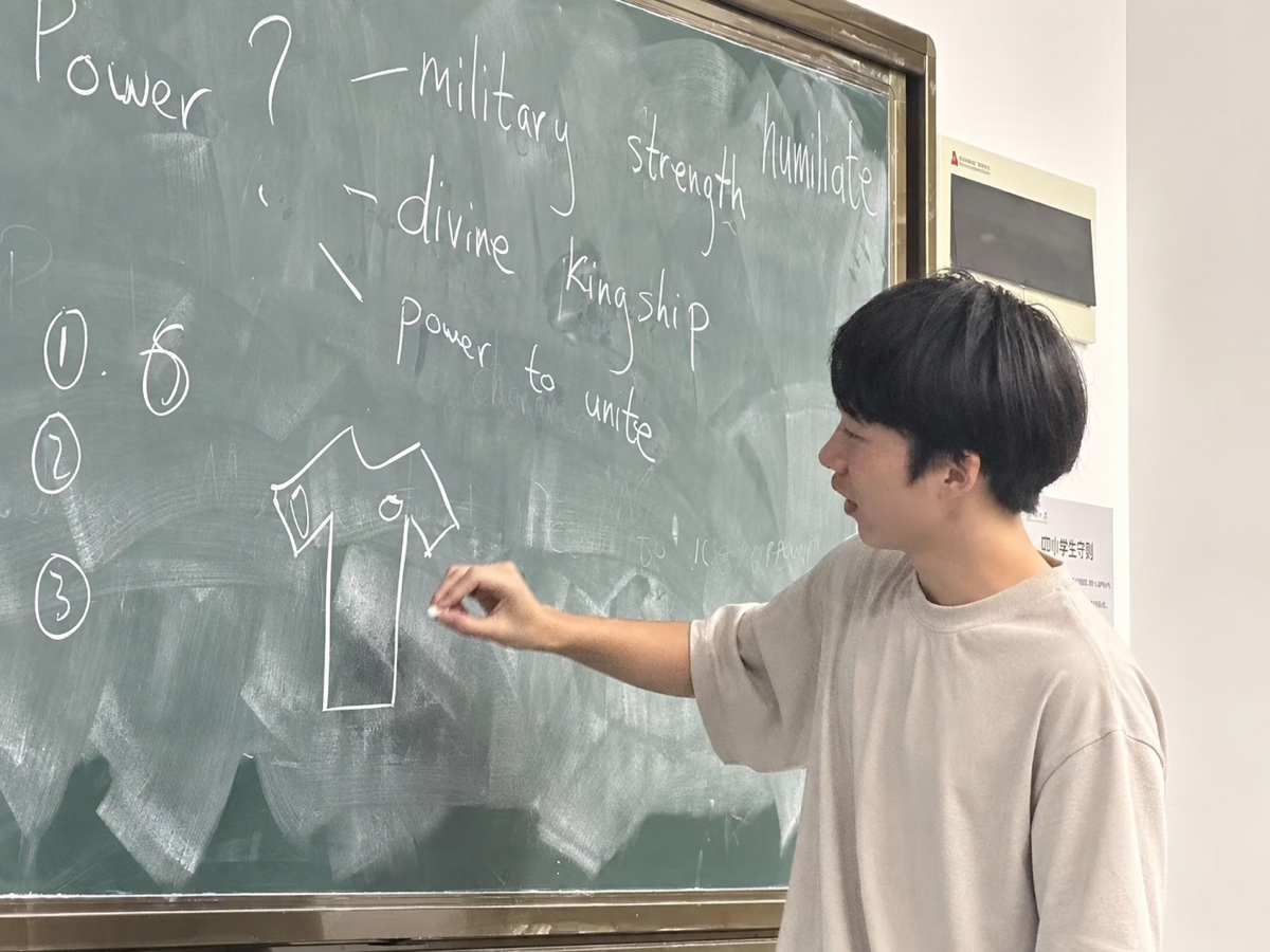 Ben writing on a classroom chalkboard